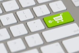 Einkaufswagen auf Tastatur als Symbol E-Commerce mit Computer